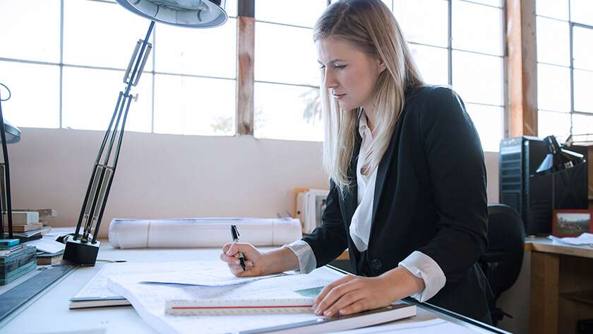 woman in black blazer going over paperwork